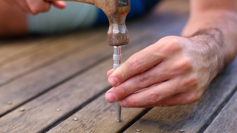 hammer hitting a center punch