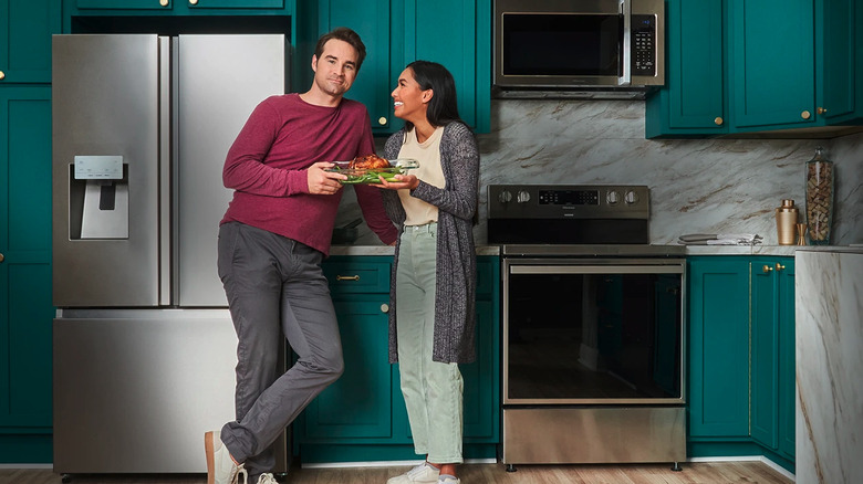 Couple standing in a kitchen with Hisense appliances