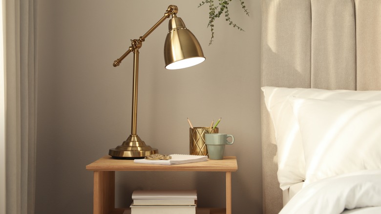 nightstand with lamp in bedroom