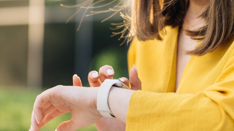 woman playing with Apple Watch