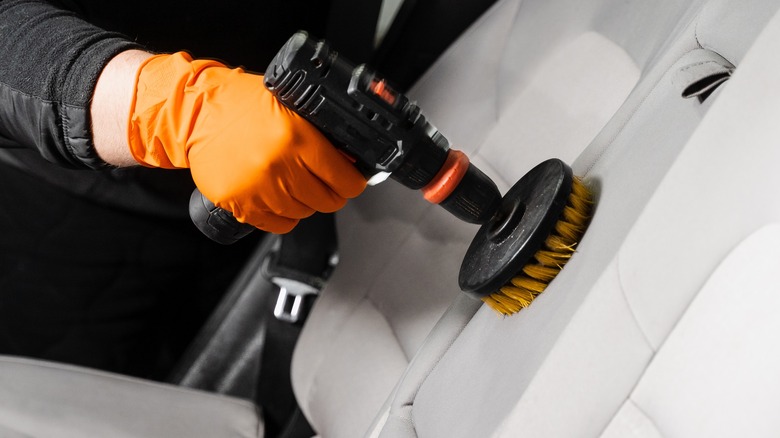 Person cleaning car interior