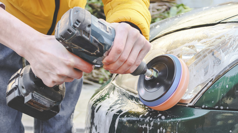 Person cleaning car exterior