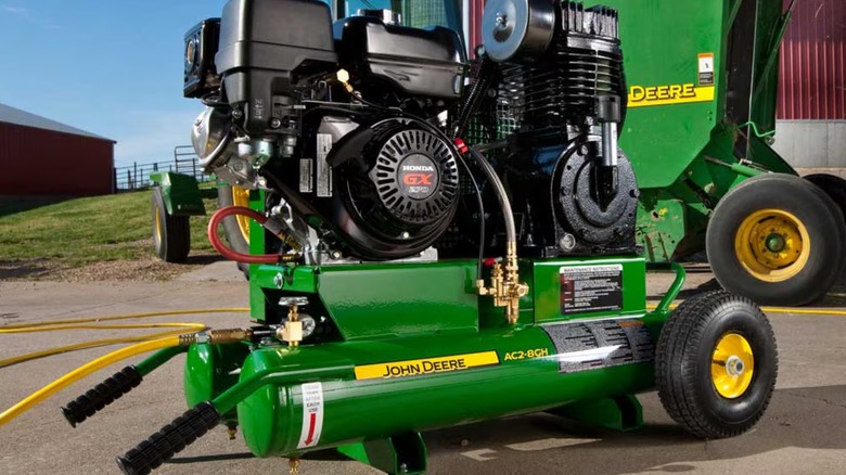 A John Deere air compressor on the ground