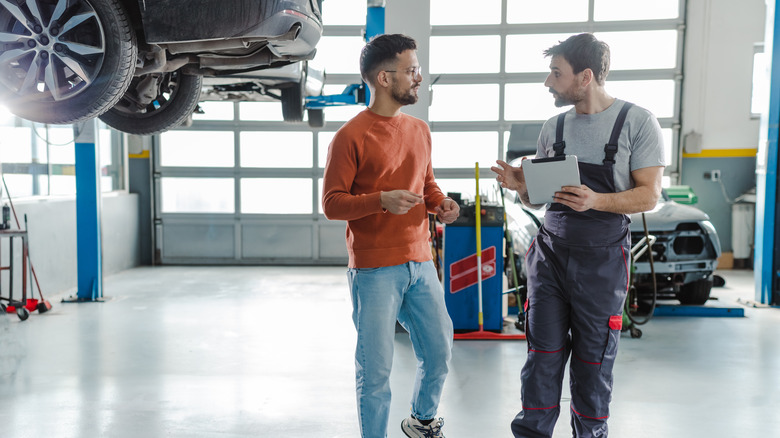 Man talking to auto mechanic