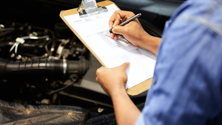 Auto mechanic with checklist