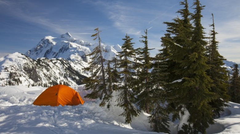 Tent in the snow with mountain in the background