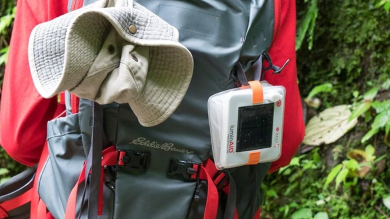 A square light hanging from backpack