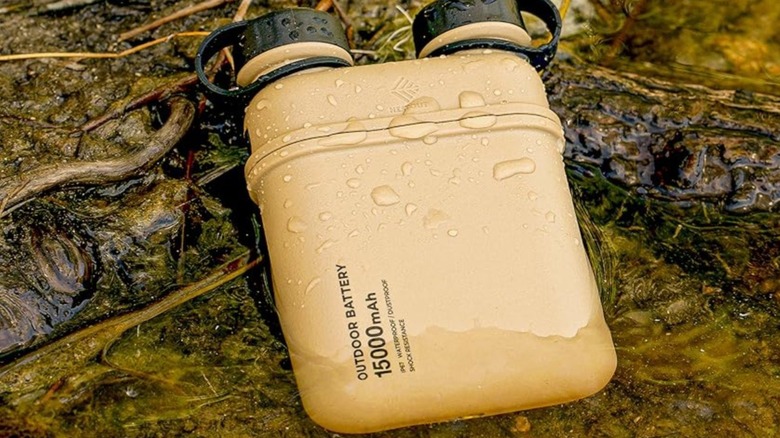 A canister power bank sitting in water