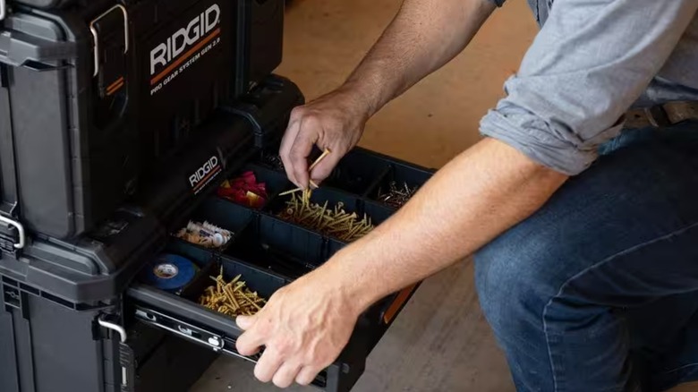 Worker getting components out of Ridgid tool box