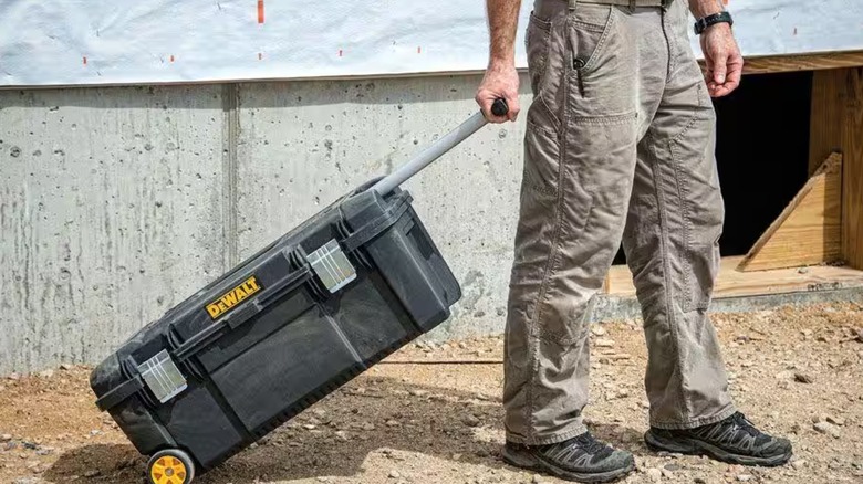 Worker pulling DeWalt rolling tool box