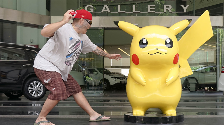 Throwing pokeball at Pikachu