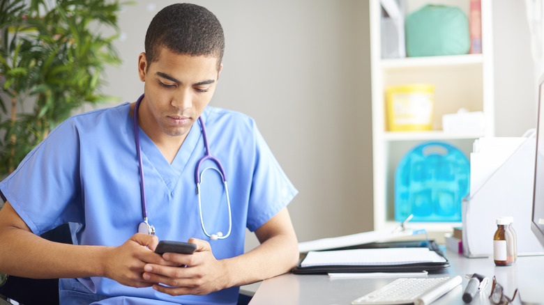 Medical student using mobile phone