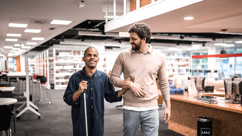 blind man walking with a friend