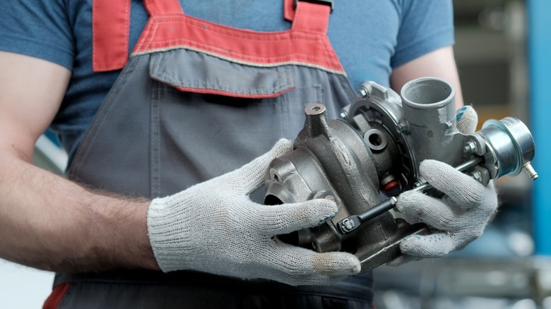 Person holds a turbocharger