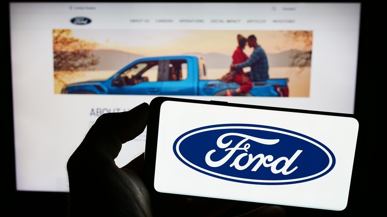 Ford website on computer, logo on phone