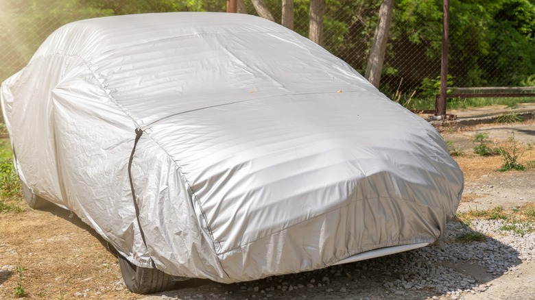 Parked vehicle with a car cover