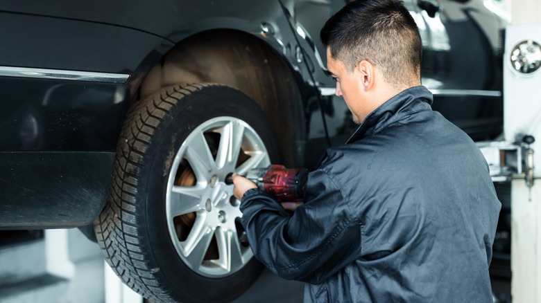 Mechanic working on car tire