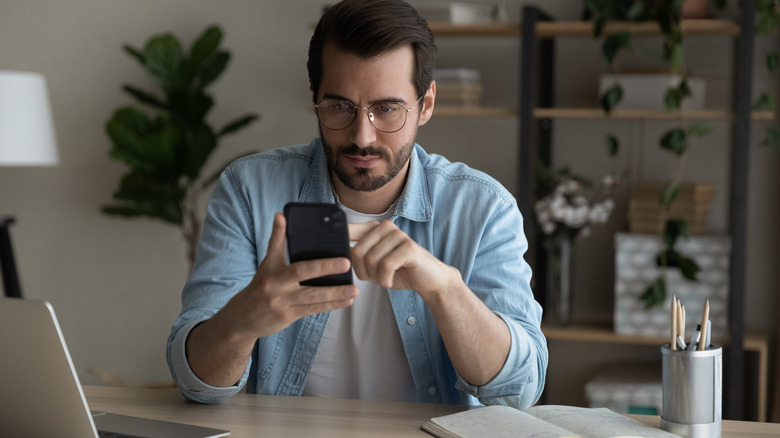 Man looking at his iPhone