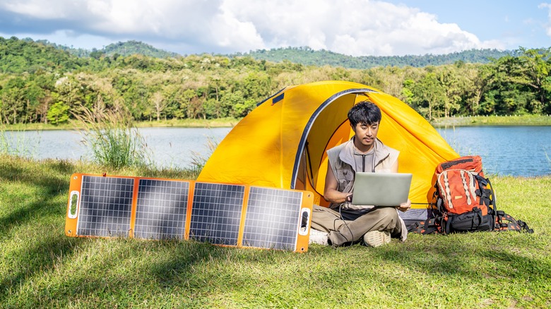 Man using solar powered laptop