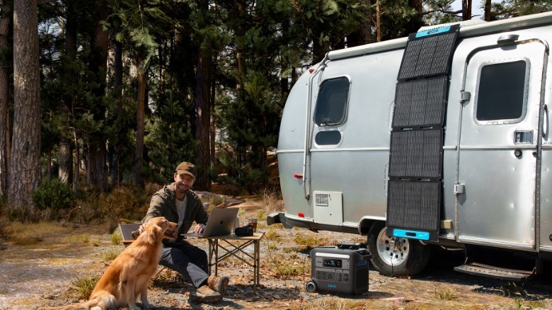 Man camping with solar panels on trailer