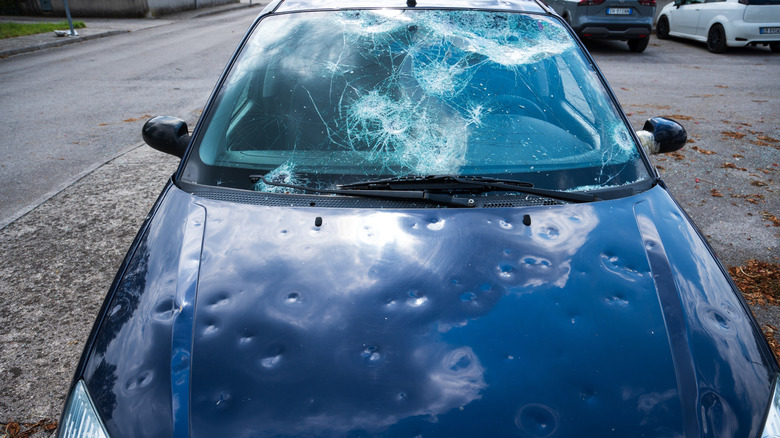 Hail Damaged Car With Broken And Fractured Windshield