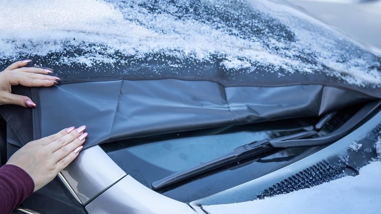 EcoNour Windshield Cover Following Winter Storm Peeling Back To Show Clear Windshield