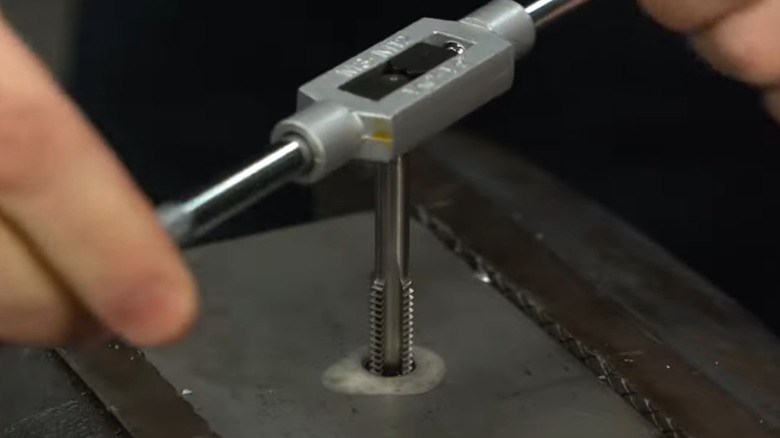 Using a tap and die set to rethread a hole