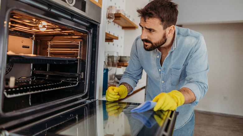 Guy looking in oven