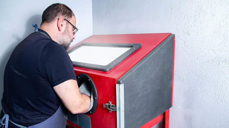 Man using sandblaster