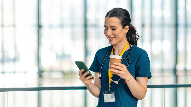 A medical professional holding a smartphone