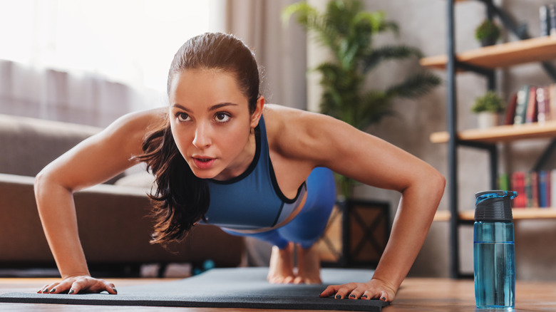 Woman doing push-ups at home