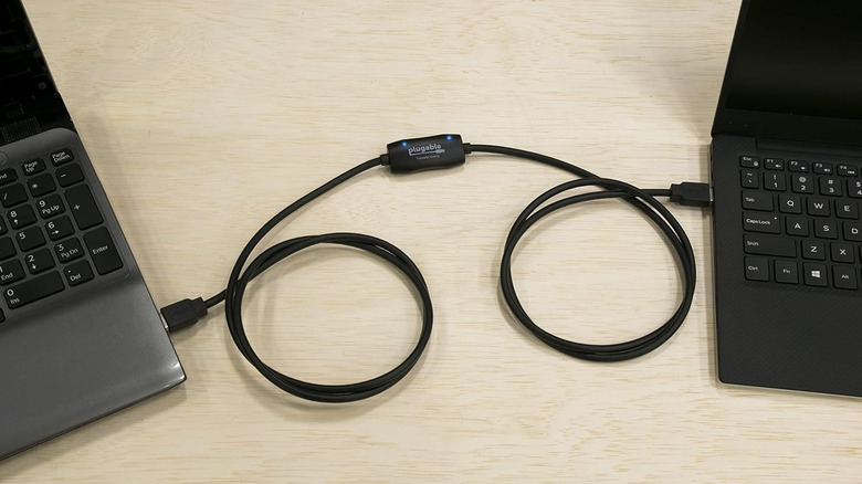 Two laptops connected using USB data transfer cable