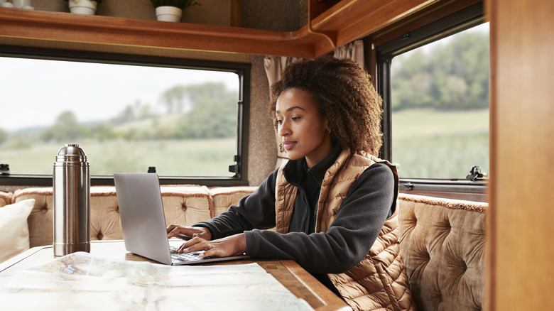 Woman with laptop on fold-out table