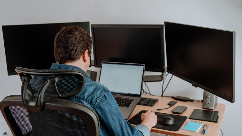 Man working with multi-monitor setup