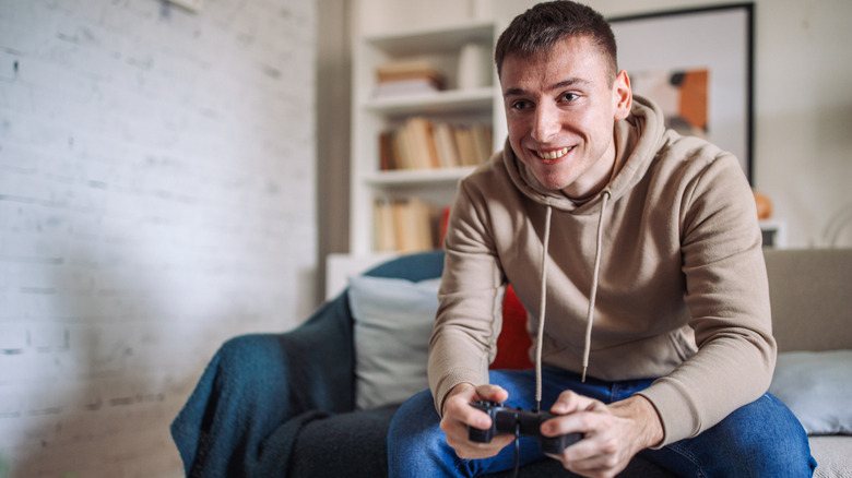 man holding a wired gaming controller