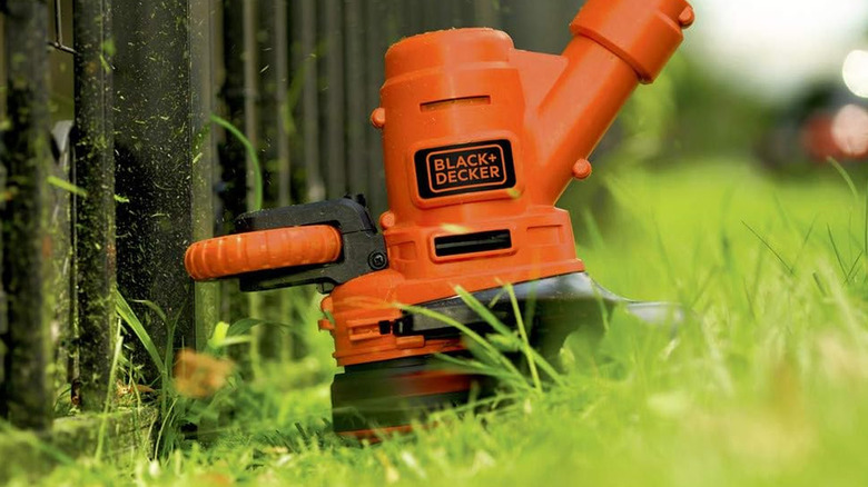 black+decker string trimmer by fence