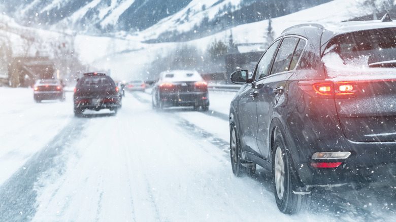 Cars driving on highway in snowstorm