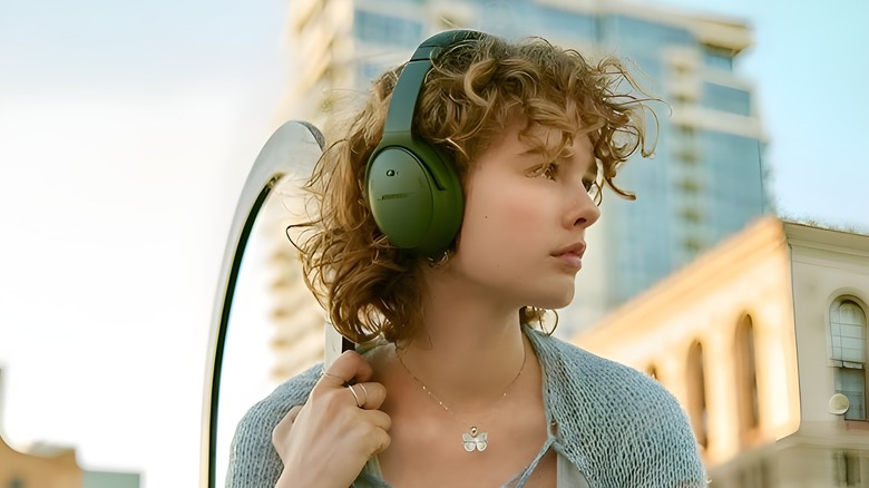 Girl wearing green colored headphones