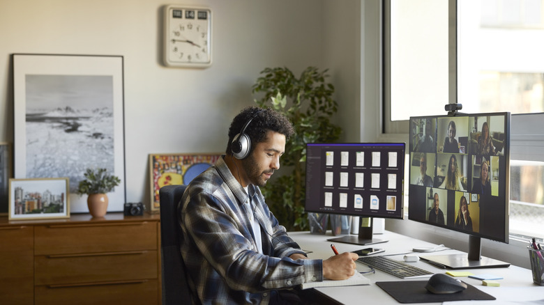 Man taking notes while on video call