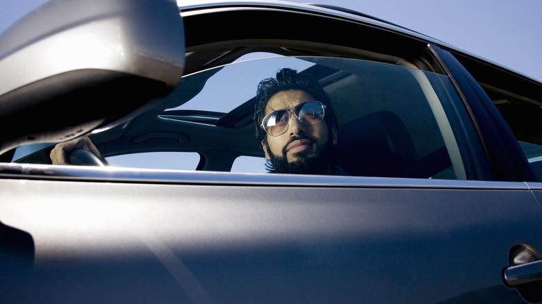 Man looking out a car Window