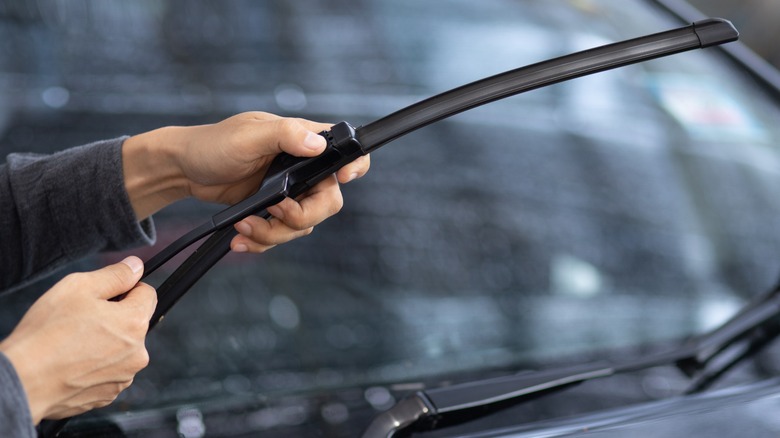 man checking windshield wipers