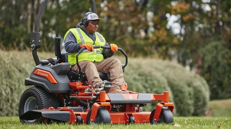 Man on Husqvarna Z560LS mowing grass