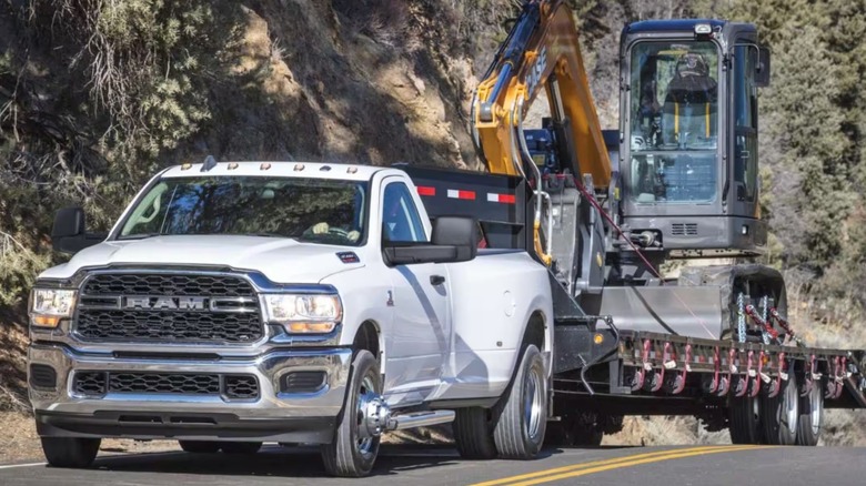 Ram 3500 towing heavy equipment.