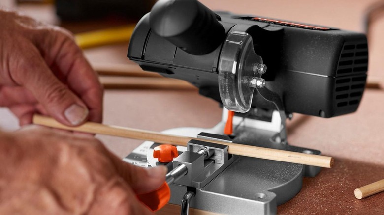 Harbor Freight's mini cut-off saw being prepared to cut through wood.