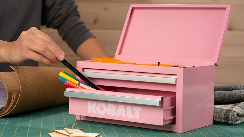 Person putting marker inside of pink Kobalt mini drawer