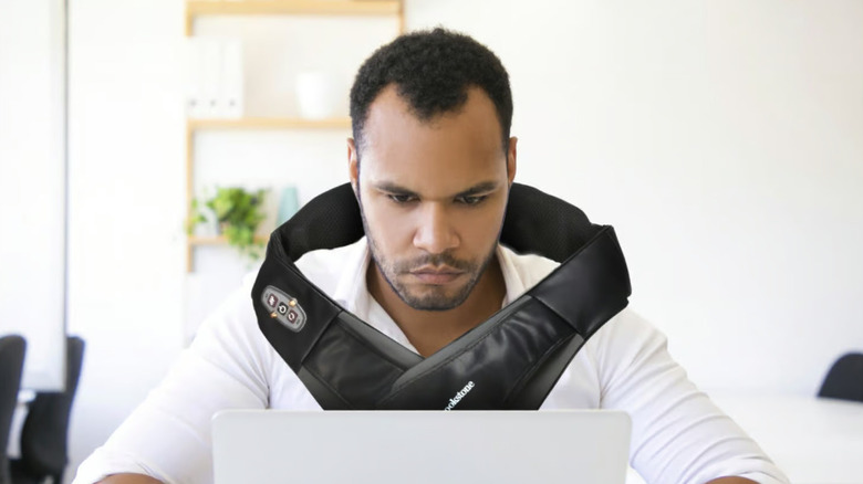 Man wearing Shiatsu neck and shoulder massager