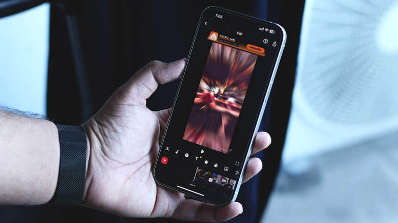 Holding a phone running the InShot video editing app