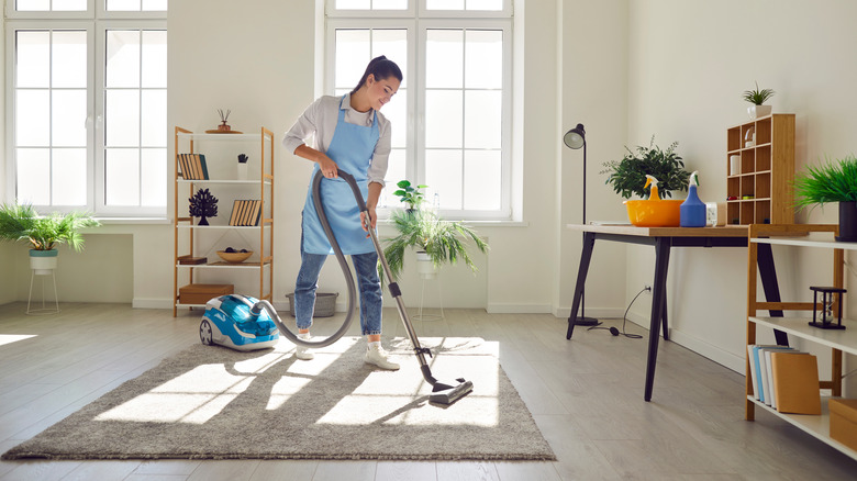 Woman vacuuming floor