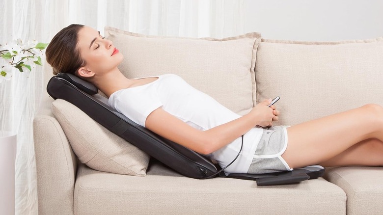 woman using massage cushion