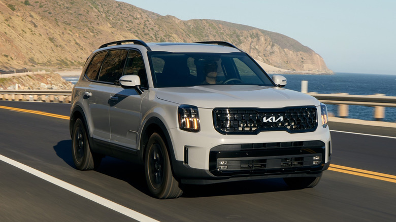 2024 Kia Telluride driving along a coastal highway